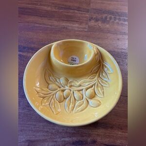 This is a yellow majolica divided olive bowl, made in Italy.